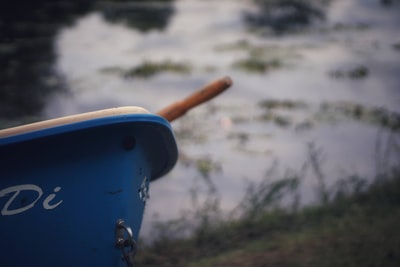 blue and white plastic bucket with brown handle